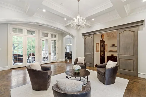 a living room with furniture and a chandelier
