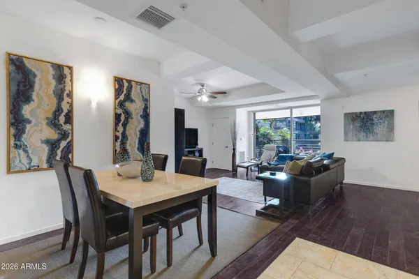 a dining room with furniture and wooden floor