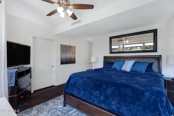 a bedroom with a bed and a flat screen tv