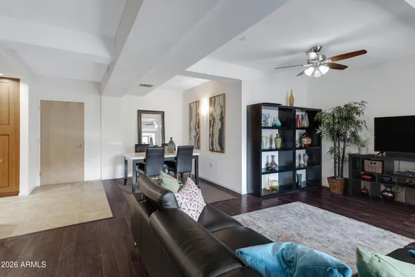 a living room with furniture a flat screen tv and a table