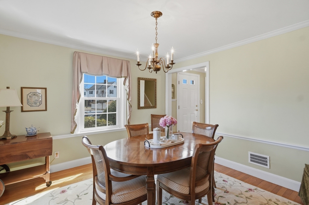 16 Cheswick Road Arlington, MA 02474 - Photo 7 of 35 a dining room with furniture a chandelier and wooden floor