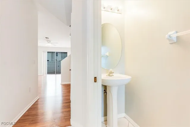 a view of a bathroom with a sink and mirror