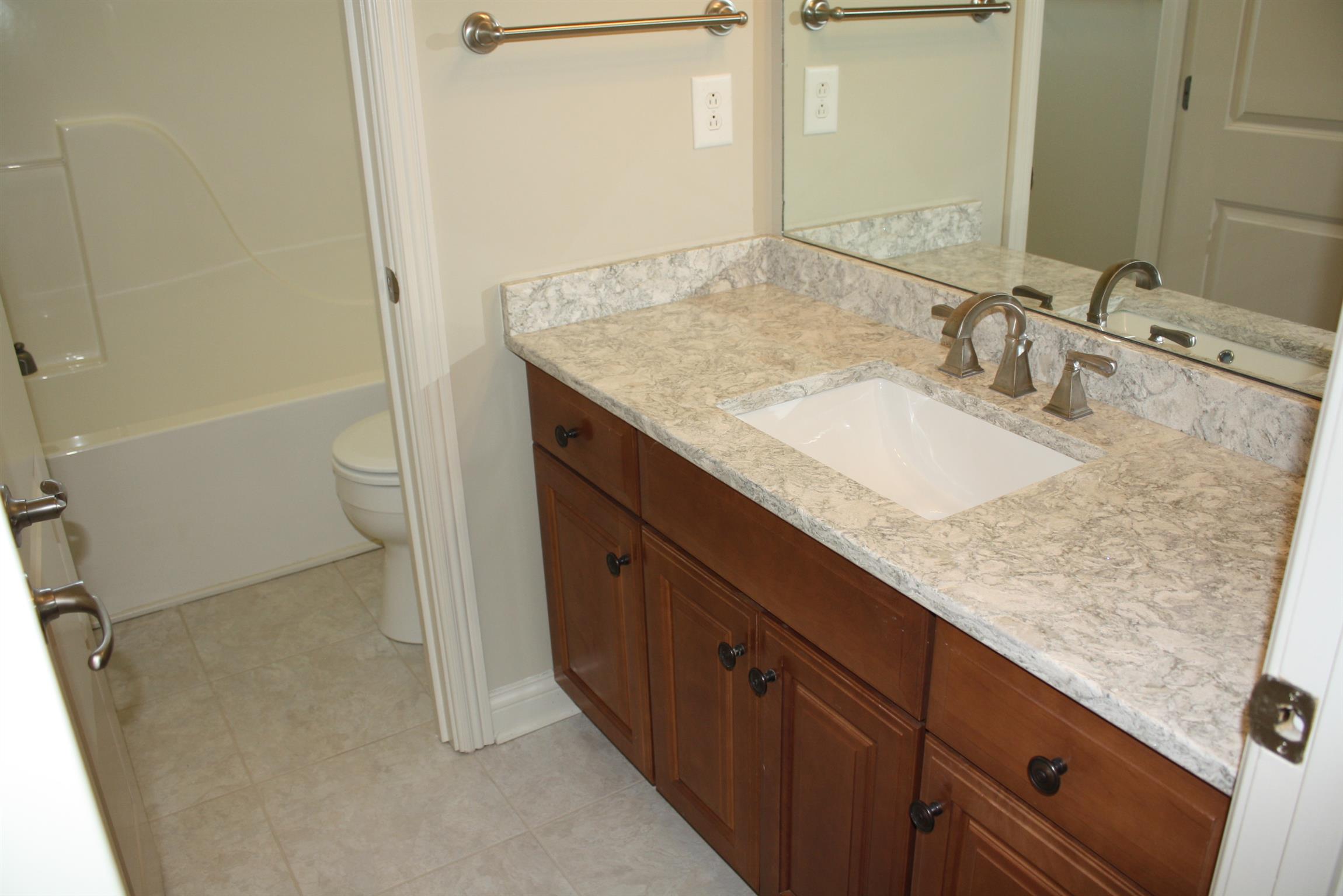 3620 Guthrie Road Clarksville, TN 37043 - Photo 19 of 30 a bathroom with a granite countertop sink and a mirror