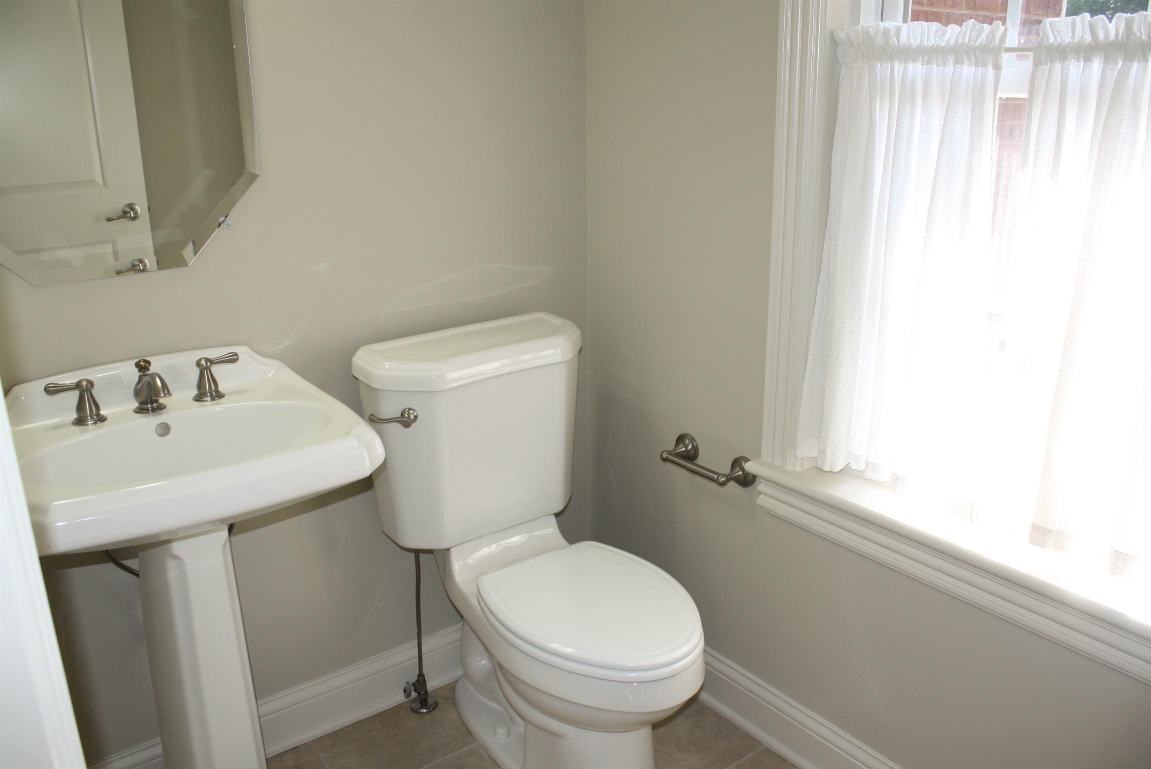 3620 Guthrie Road Clarksville, TN 37043 - Photo 22 of 30 a white toilet sitting next to a bathroom sink