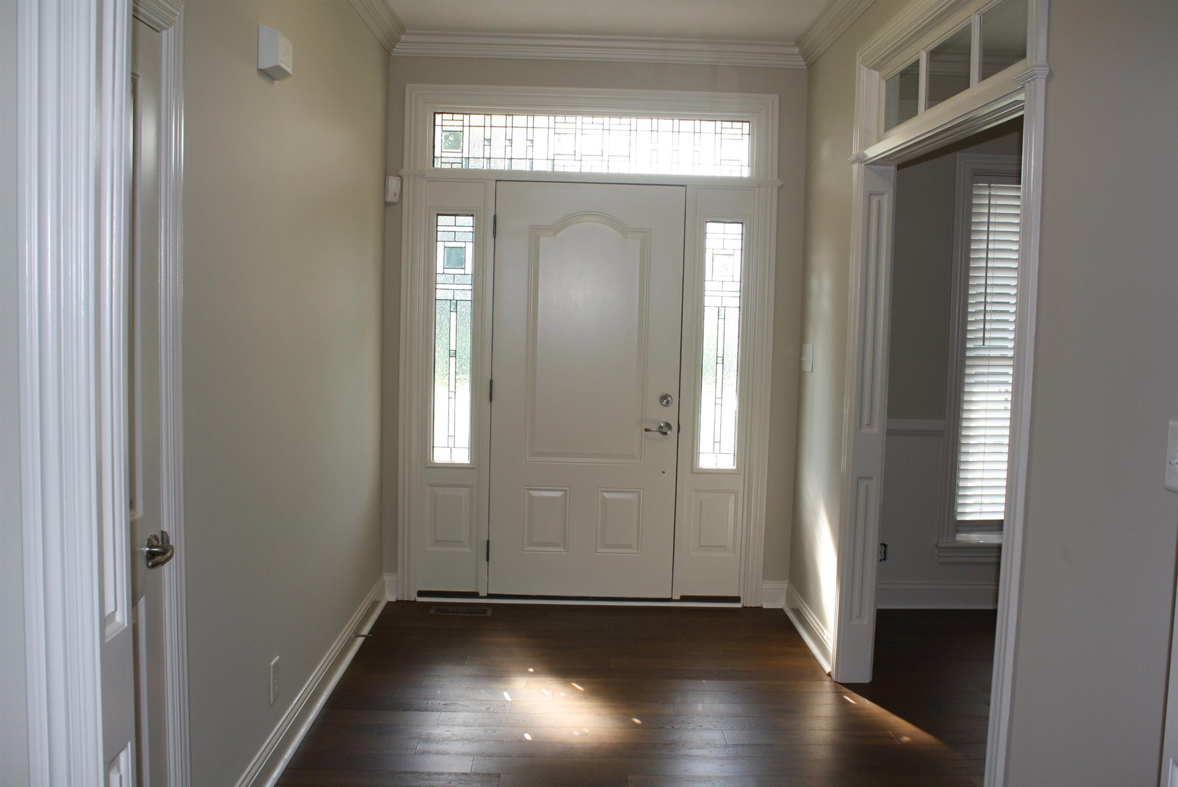 3620 Guthrie Road Clarksville, TN 37043 - Photo 4 of 30 an empty room with wooden floor mirror and windows