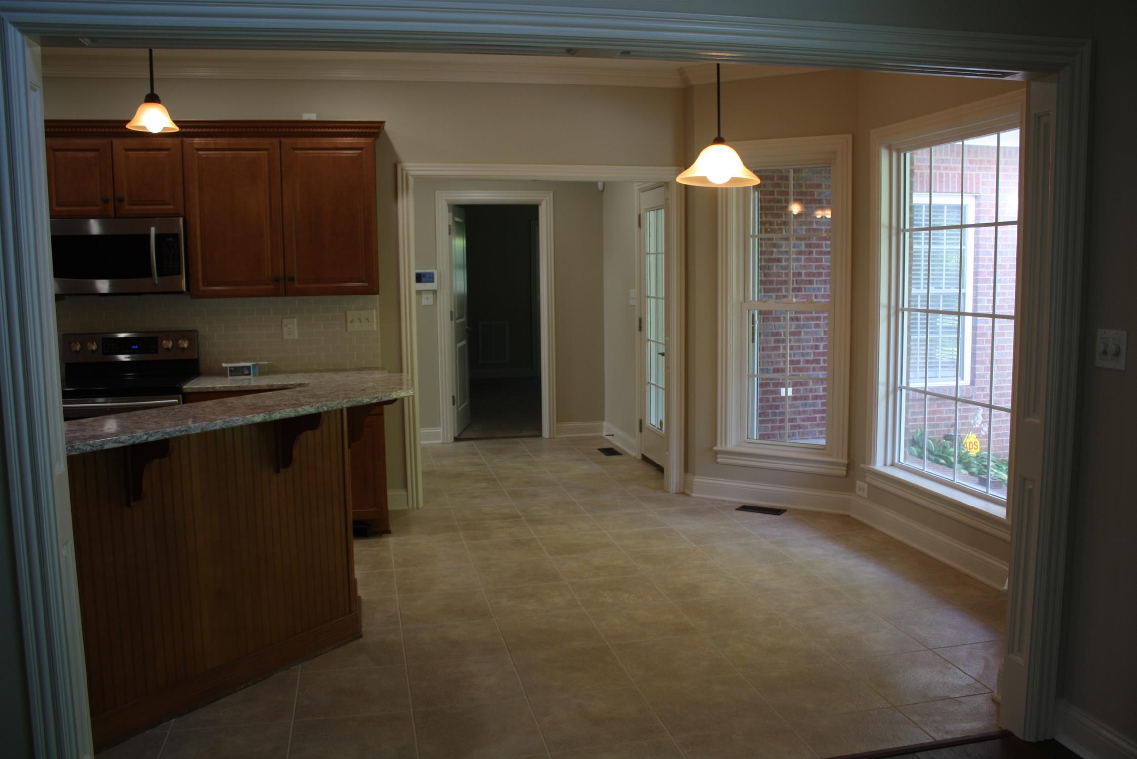 3620 Guthrie Road Clarksville, TN 37043 - Photo 7 of 30 a view of a kitchen with a sink window and wooden floor