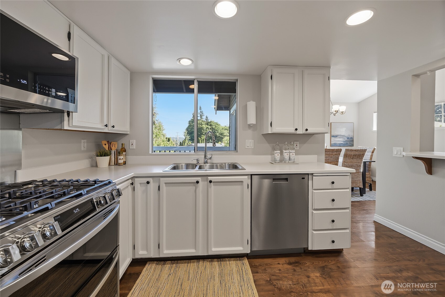 23707 Meridian Place West Bothell, WA 98021 - Photo 13 of 40 a kitchen with stainless steel appliances a stove a sink and a microwave