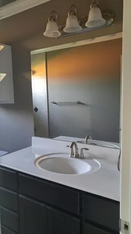 a bathroom with a sink and a mirror