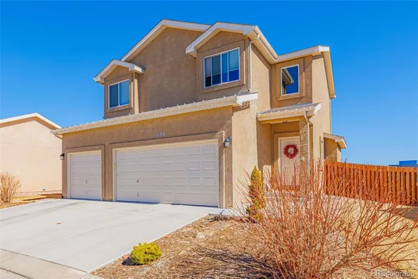 a front view of a house with a garage