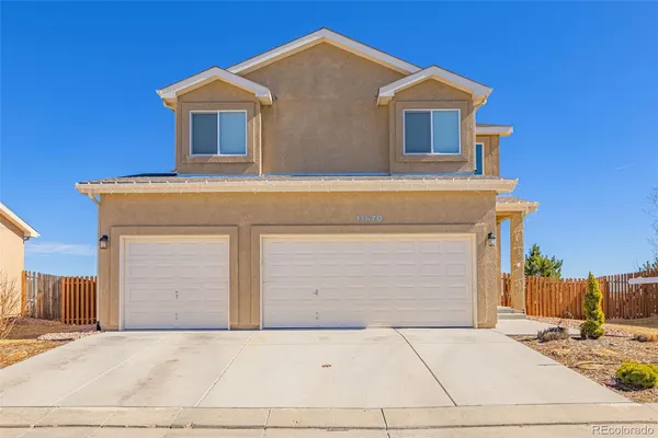 a front view of a house with garage