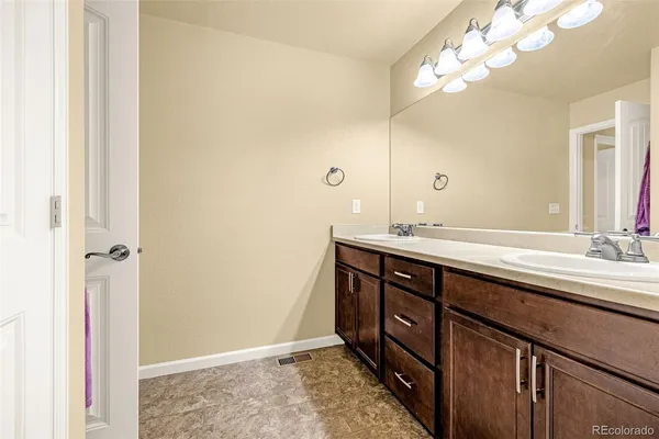 a bathroom with a double vanity sink and a mirror