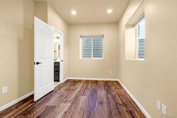 a view of a room with wooden floor and window