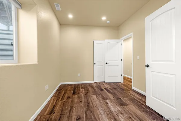 a view of a room with wooden floor and brick walls