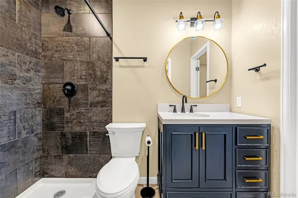 a bathroom with a sink mirror and toilet