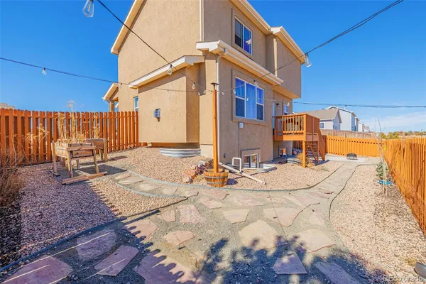 a view of a backyard with chairs