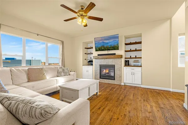 a living room with furniture a fireplace and a flat screen tv