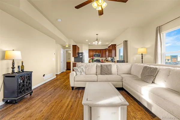 a living room with furniture or chandelier and a wooden floor
