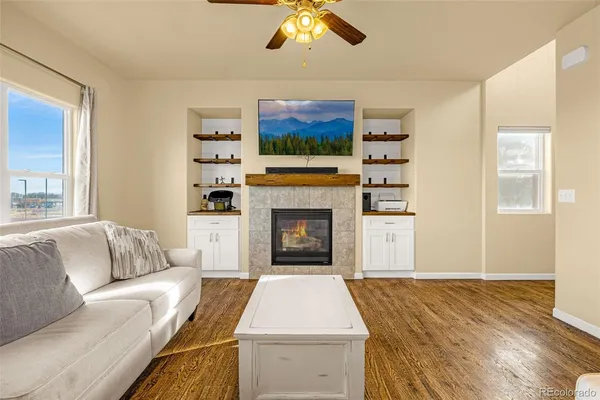 a living room with furniture and a fireplace