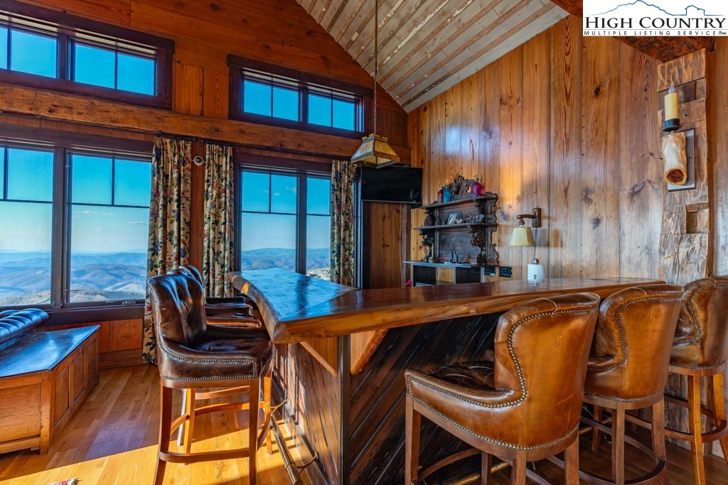 C105 Acorn Nvno Road Zionville, NC 28698 - Photo 28 of 35 a view of a patio with table and chairs with wooden floor and fence