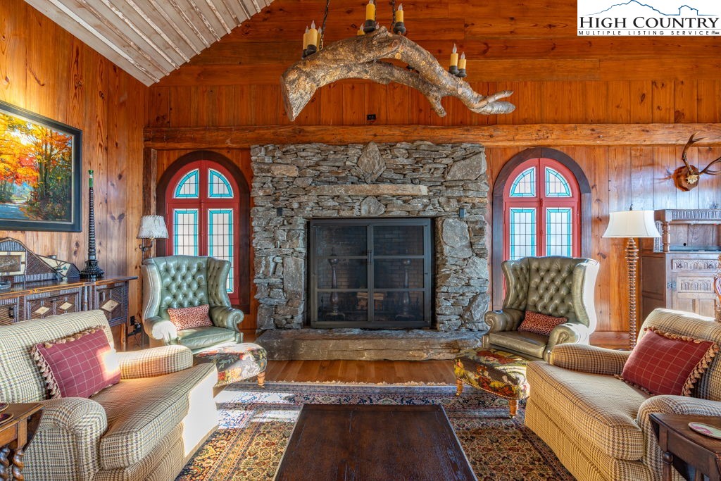 C105 Acorn Nvno Road Zionville, NC 28698 - Photo 30 of 35 a living room with furniture a fireplace and a flat screen tv