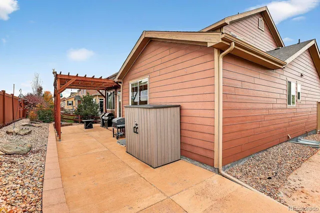 a view of a house with wooden fence
