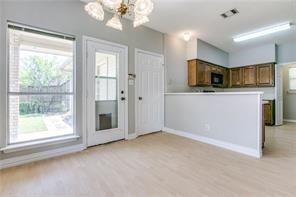 544 Lake Forest Drive Coppell, TX 75019 - Photo 12 of 24 a view of a kitchen with a sink dishwasher cabinets and a large window
