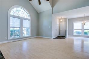 544 Lake Forest Drive Coppell, TX 75019 - Photo 15 of 24 an empty room with windows and view of wooden floor