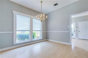 544 Lake Forest Drive Coppell, TX 75019 - Photo 16 of 24 en empty room with windows and outdoor view