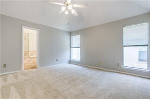 544 Lake Forest Drive Coppell, TX 75019 - Photo 22 of 24 an empty room with a windows and chandelier fan