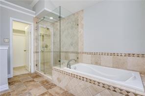 544 Lake Forest Drive Coppell, TX 75019 - Photo 5 of 24 a bathroom with a tub and a shower