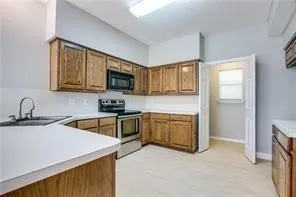 a kitchen with stainless steel appliances granite countertop a sink stove and microwave