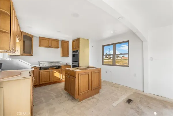 a kitchen with stainless steel appliances granite countertop a refrigerator and a stove
