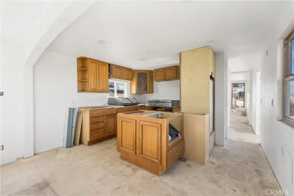 a kitchen that has a sink and a stove top oven