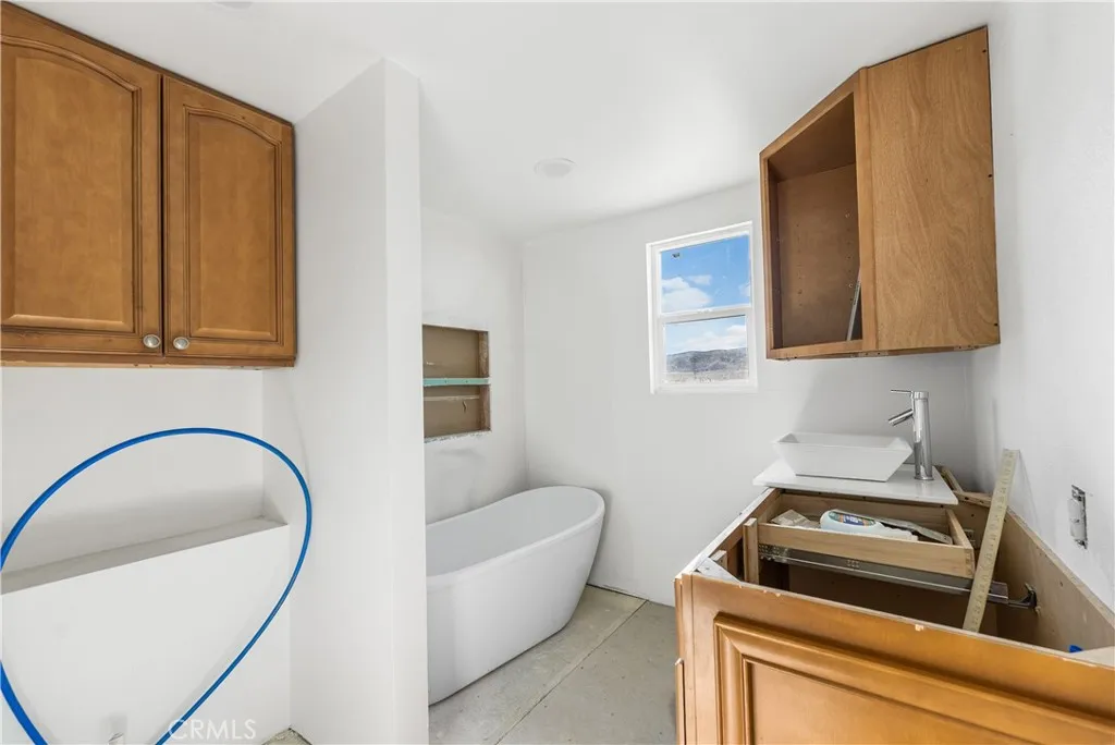 0 Bellbird Place Lancaster, CA 93534 - Photo 30 of 44 a bathroom with a granite countertop sink and a bathtub