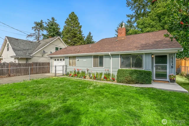 a view of a house with a yard and porch