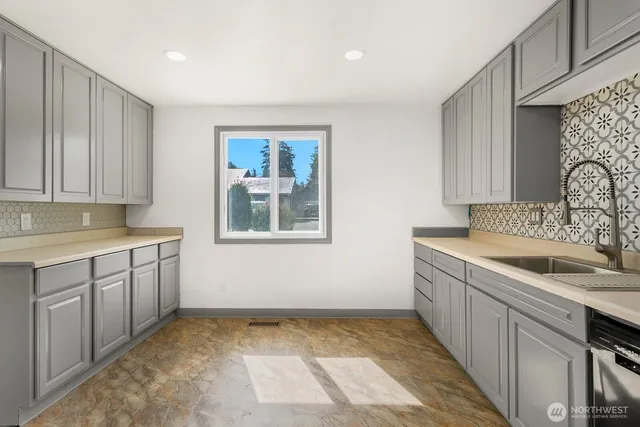 a kitchen with a sink and cabinets