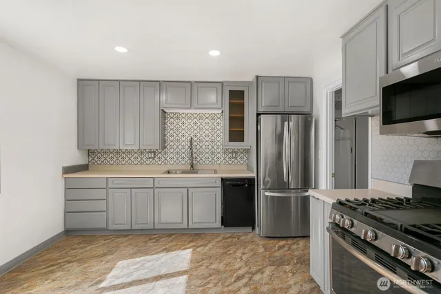 a kitchen with kitchen island granite countertop a stove and a refrigerator