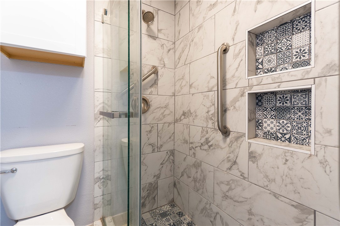6232 Weber Road Corpus Christi, TX 78413 - Photo 18 of 23 a bathroom with a toilet and a shower