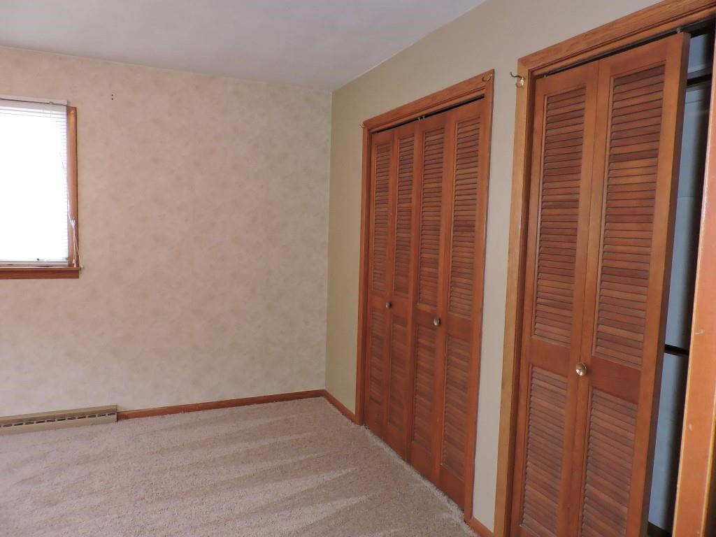 4894 Brookview Road Rockford, IL 61107 - Photo 11 of 21 a view of an empty room with wooden floor and a window