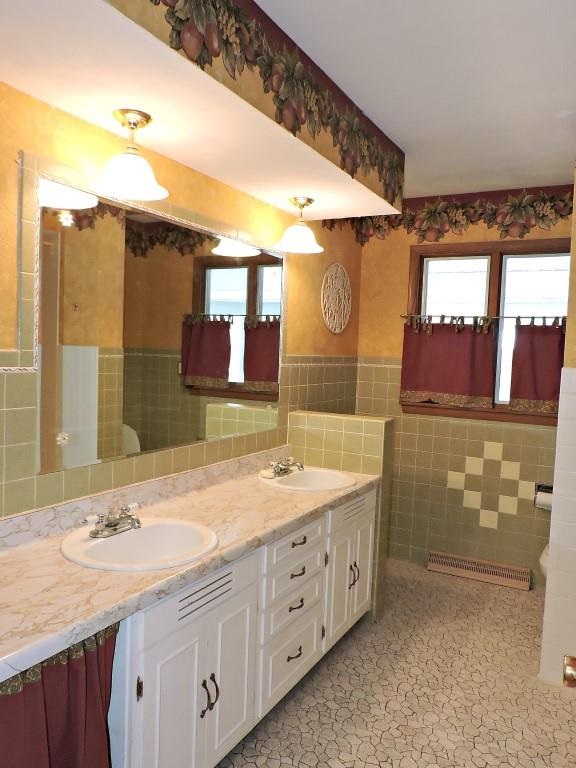 4894 Brookview Road Rockford, IL 61107 - Photo 14 of 21 a bathroom with a double vanity sink and a mirror