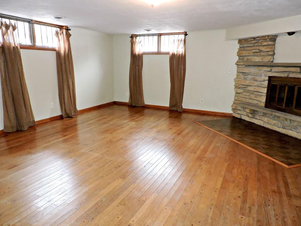 4894 Brookview Road Rockford, IL 61107 - Photo 17 of 21 a view of an empty room with wooden floor and a fireplace