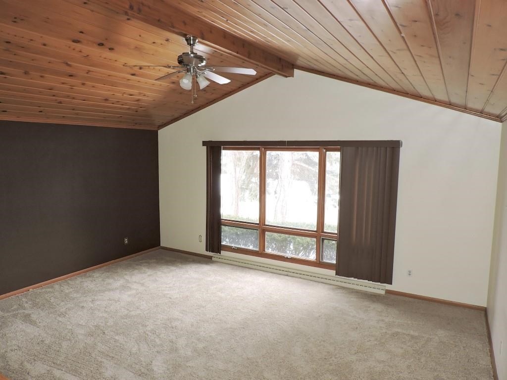 4894 Brookview Road Rockford, IL 61107 - Photo 2 of 21 an empty room with a ceiling fan and window
