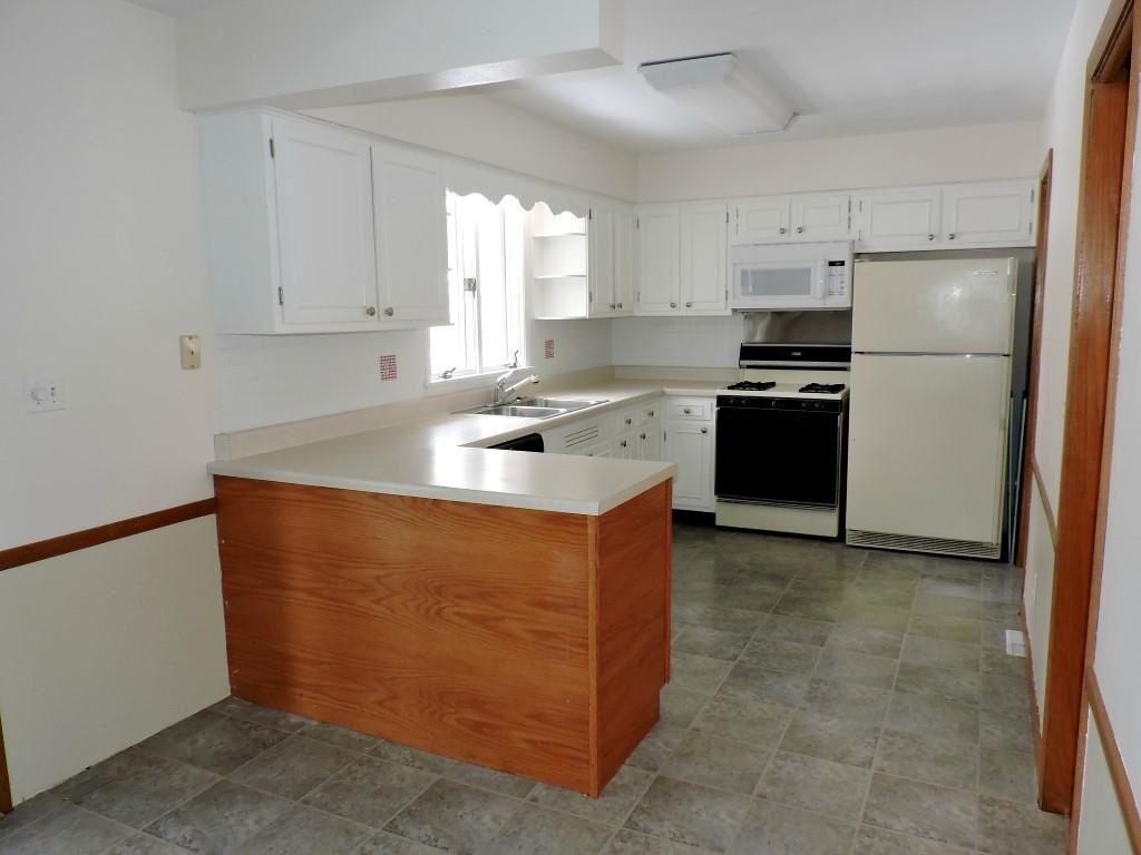 4894 Brookview Road Rockford, IL 61107 - Photo 7 of 21 a kitchen with stainless steel appliances granite countertop a sink stove and refrigerator
