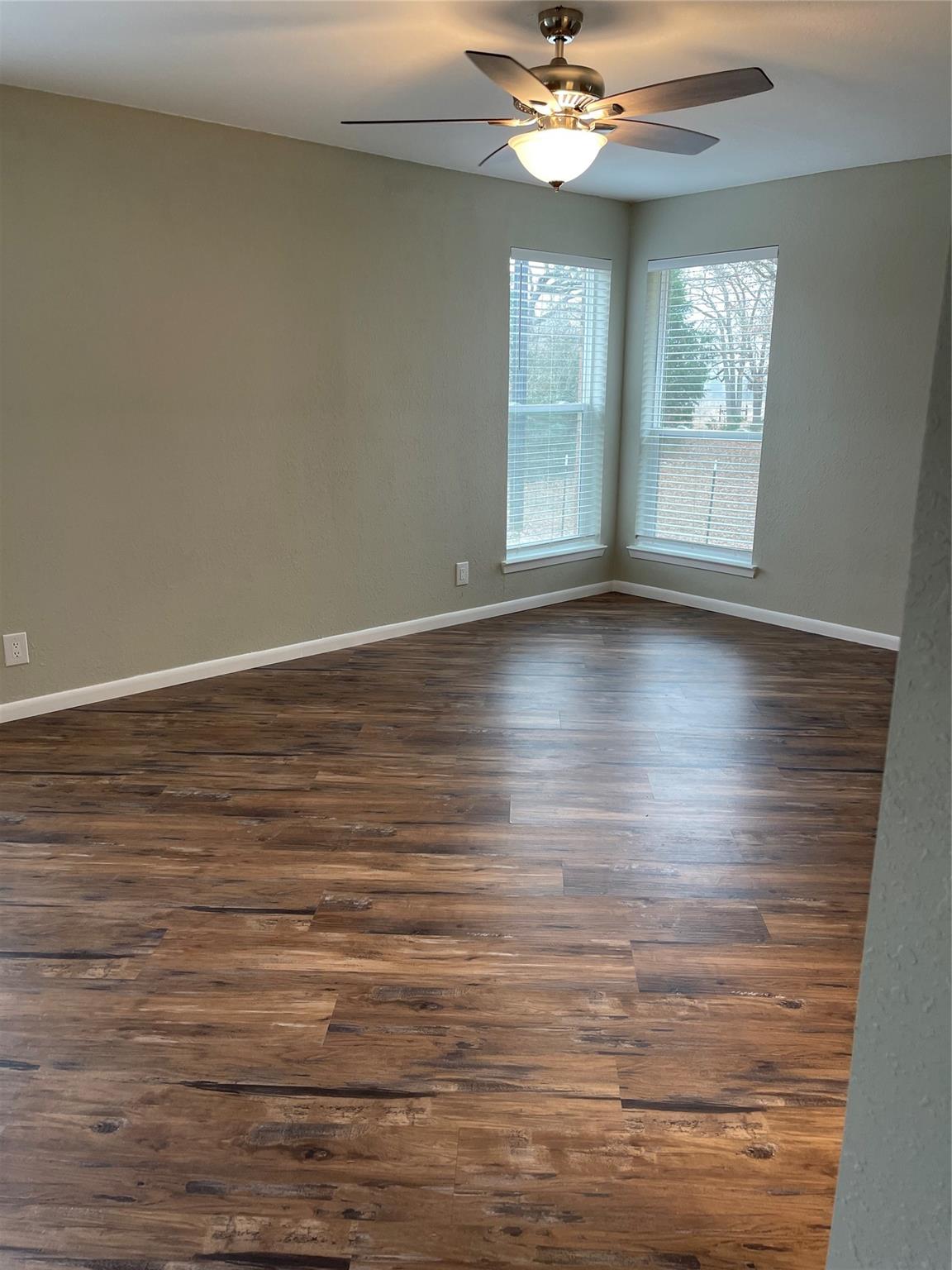 139 Farm To Market 696 Elgin, TX 78621 - Photo 14 of 27 Spare room with dark wood-style flooring and ceiling fan