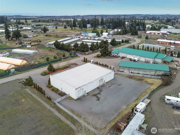 an aerial view of a house with swimming pool and outdoor seating