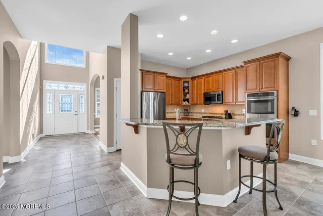 a dining room with furniture a chandelier and wooden floor