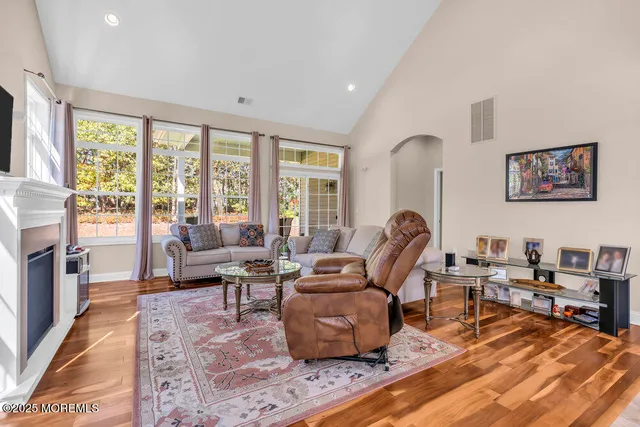 a living room with furniture fireplace and flat screen tv
