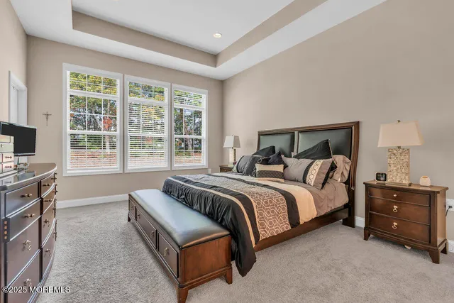 a bedroom with a bed and dresser with window