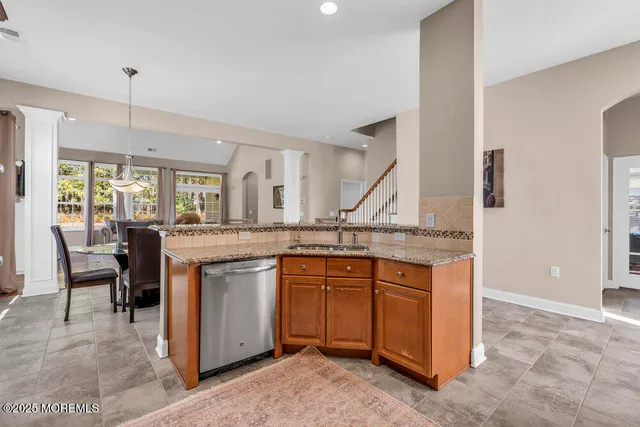 a kitchen with stainless steel appliances granite countertop a refrigerator sink and stove