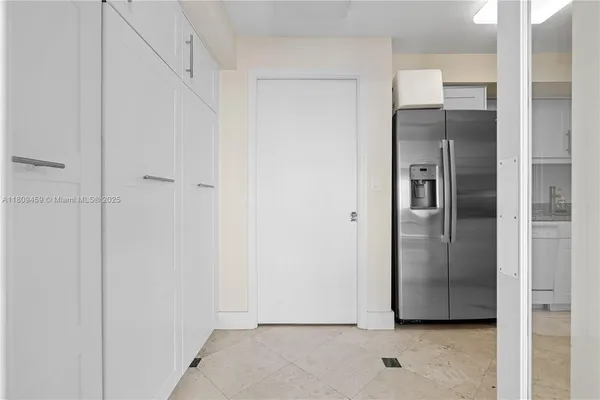 a view of a refrigerator in kitchen